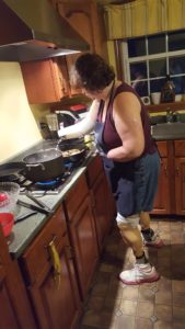quadruple amputee woman cooking over stovetop