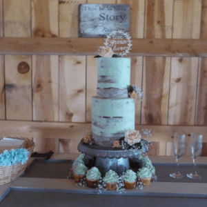 naked wedding cake, 2 tiers, green frosting, cupcakes at bottom