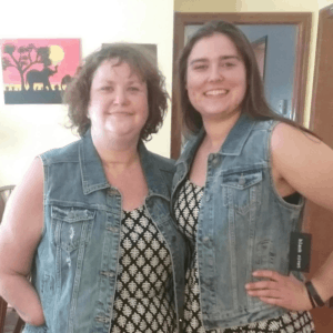 daughter and mother, best friends, are wearing matching dresses and denim vests