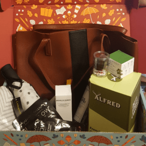 box filled with tote bag, umbrella, and many other things