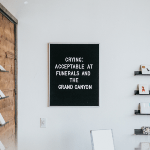 crying: acceptable at funerals and the grand canyon written in white letters, black board on white wall
