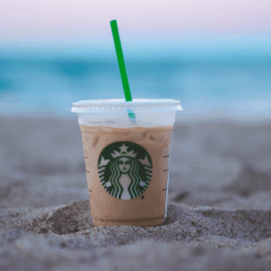 starbucks iced coffee resting in sand, pay it forward ideas