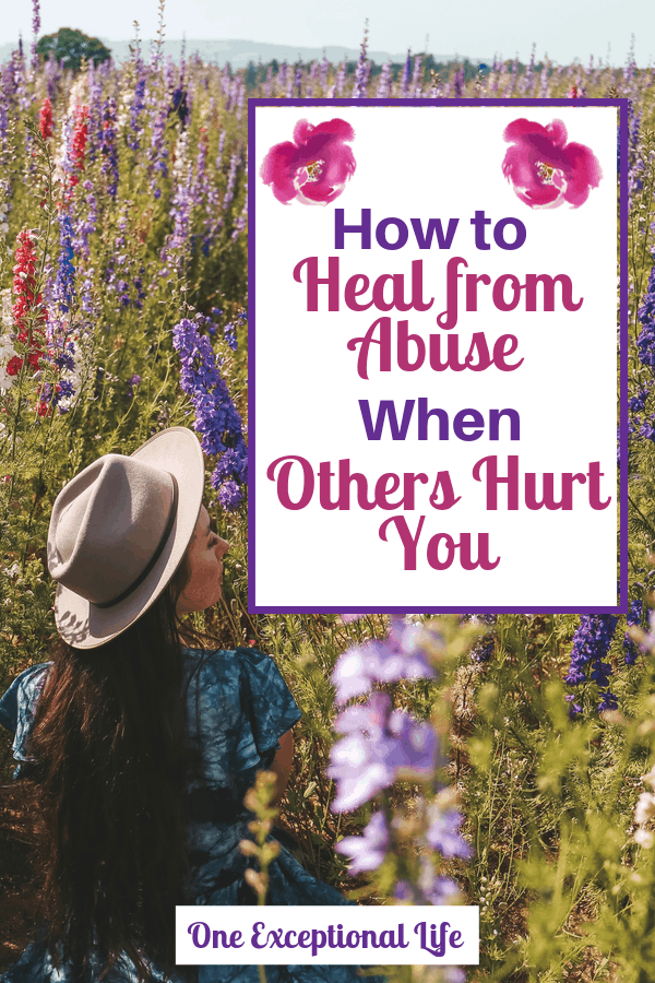 woman in hat in a field of flowers, heal from abuse