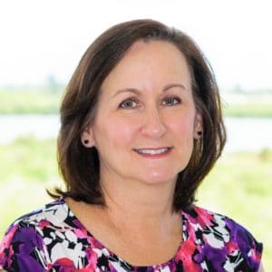 midlife brunette woman flowered shirt