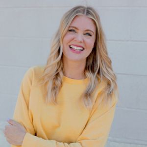 pretty blonde smiling lady, yellow sweater 