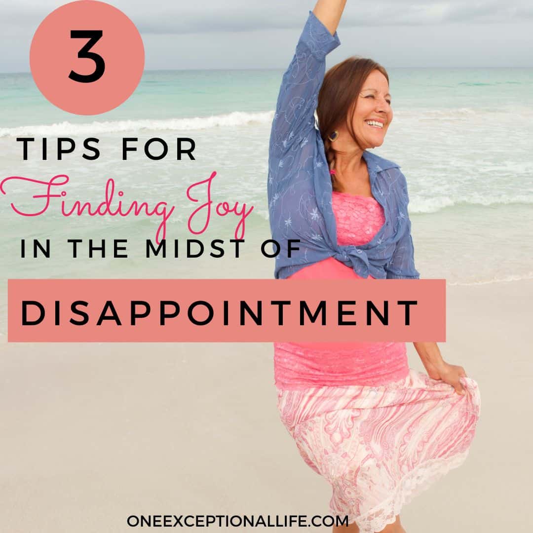 smiling brunette woman on beach, pink dress, finding joy in midst of disappointment